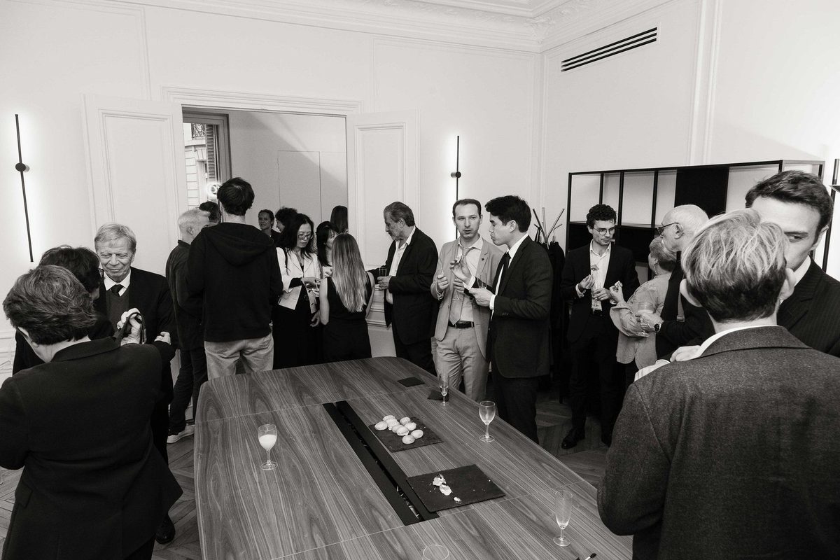 Guests talking in front of the works on display